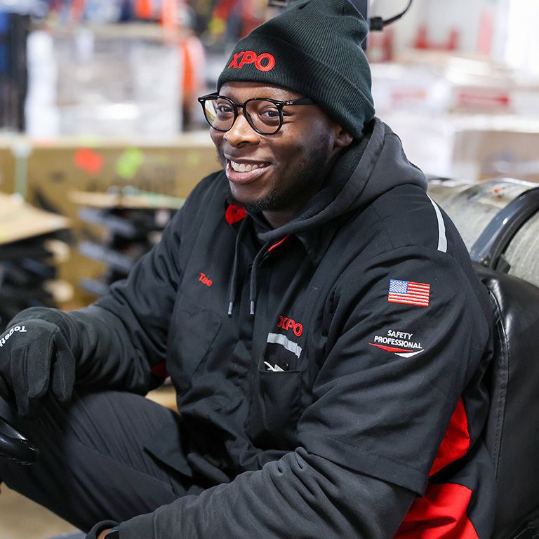 A smiling XPO dockworker An XPO dockworker sitting on his forklift