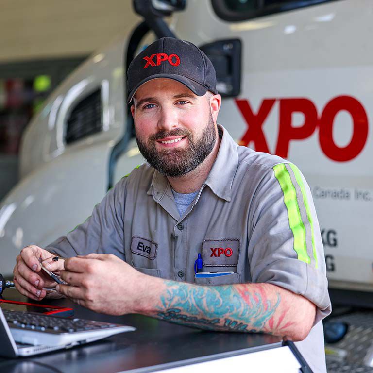 A happy XPO LTL truck mechanic An XPO mechanic working on some electronics