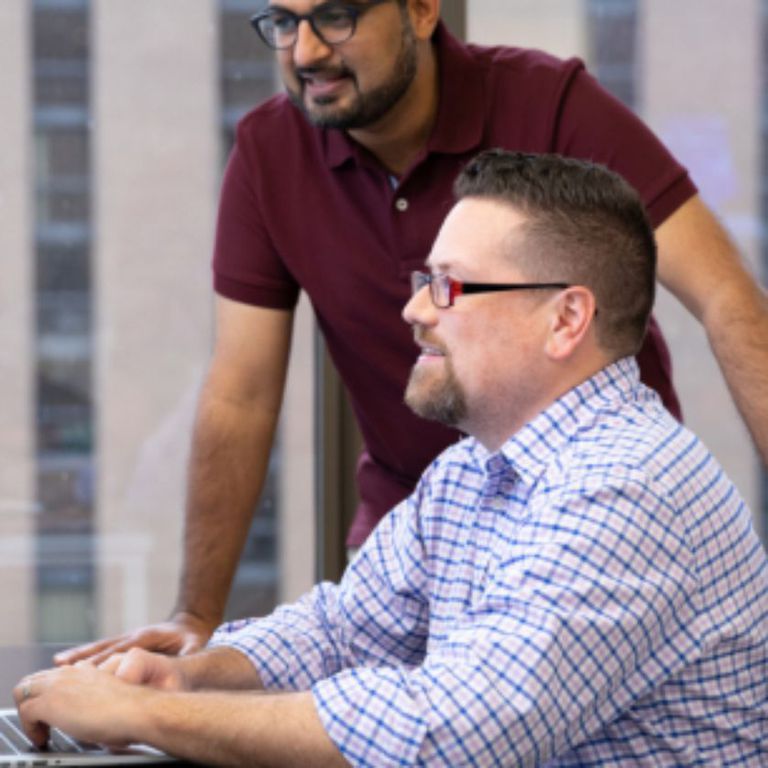 Operations and sales Two employees discussing something on the computer