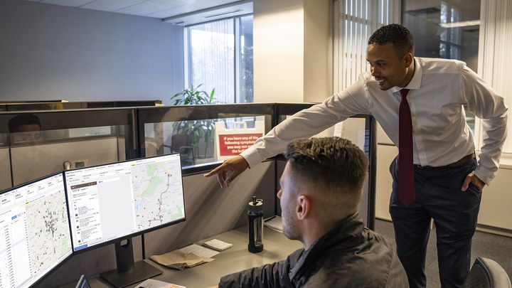 Digital Collaboration in the supply chain Two men looking at data on a monitor