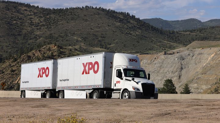 XPO Announces Cash Tender Offer XPO double trailer with mountains in the background