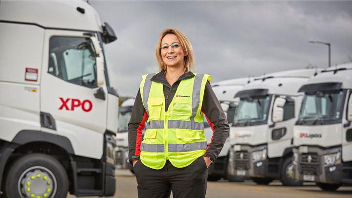 XPO Reports Gender Gap Data XPO female employee in front of trucks